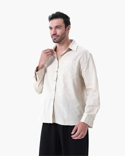 Man wearing beige linen shirt and black pants on white background, casual mens fashion