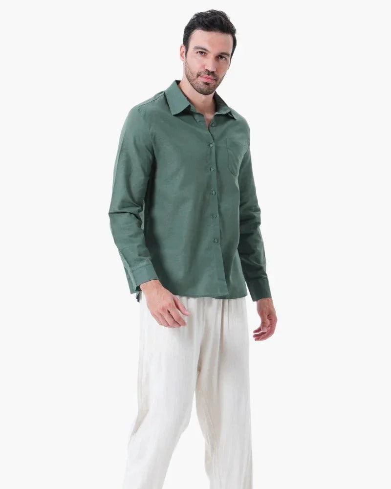 Man modeling green linen shirt and white linen pants on white background