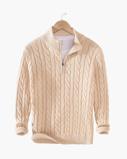 Beige cable knit quarter zip sweater on hanger against white background