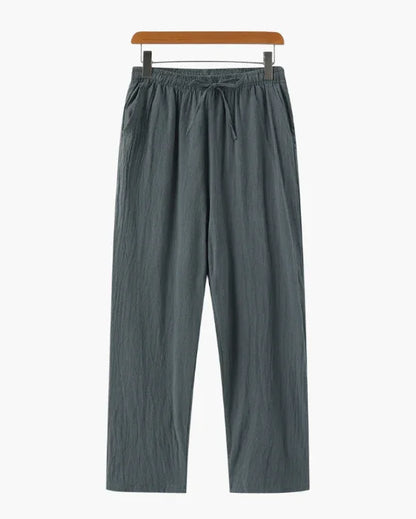 Loose fit gray drawstring pants with an elastic waist, displayed on a hanger