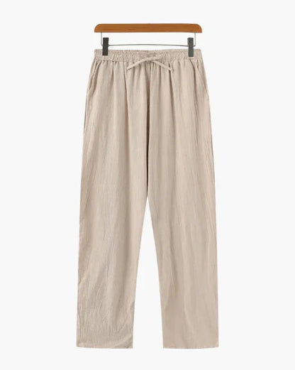 Beige linen drawstring pants with elastic waist on hanger, minimalist style