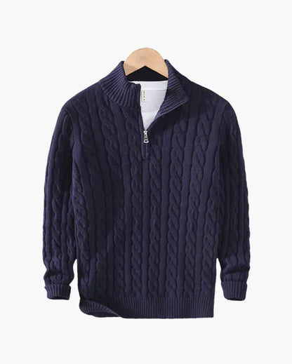 Navy blue cable knit quarter zip sweater on wooden hanger against white background