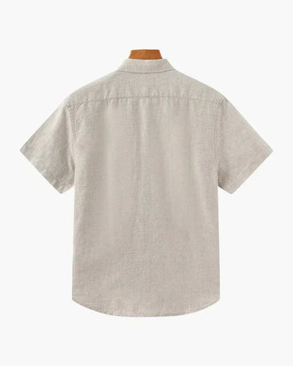Beige linen short sleeve shirt, back view, on wood hanger against white background