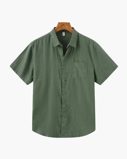 Green linen short sleeve button-up shirt with chest pocket on hanger