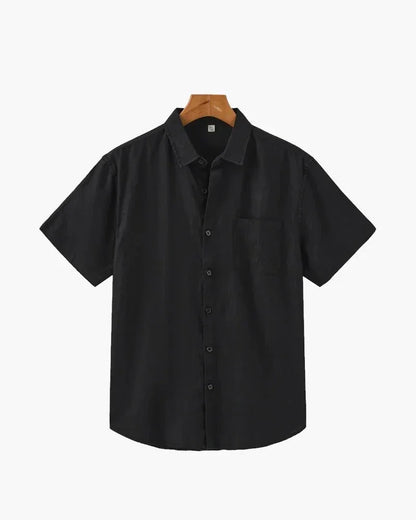 Black linen short sleeve button-up shirt with chest pocket on hanger